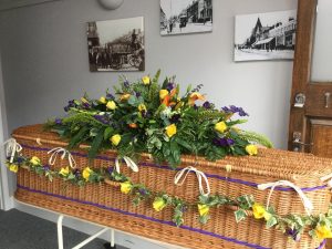 Eco-Friendly Coffin with floral tribute supplied by Albert Parr in Beckenham